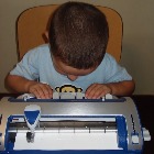photo of a child using a braille typewriter