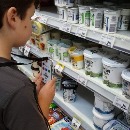 Photo of a child using a scanning device in a shop
