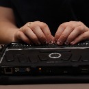 photo of a person using a braille typewriter