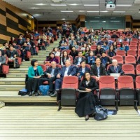 Photo of a large class conference filled with students